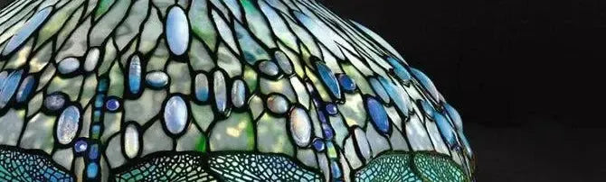 Domed stained glass shade featuring blue and green iridescent cabochons with dragonfly wing patterns