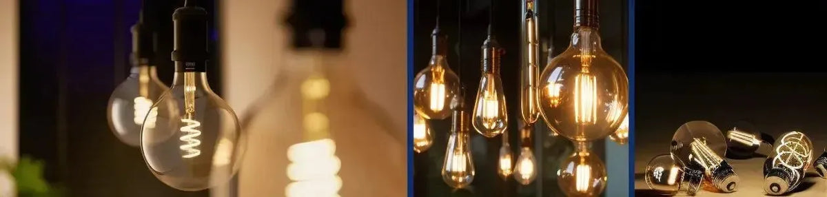 Clear glass LED globes with visible warm filaments hanging in clusters and resting on a dark surface