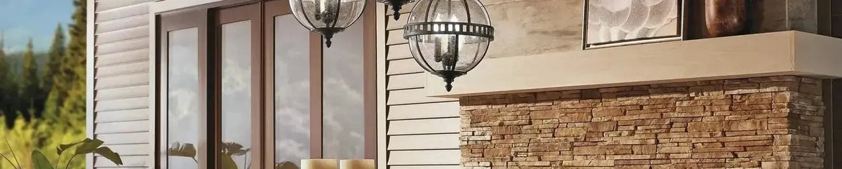 Black globe pendants with seeded glass hanging on a stone patio near a sliding door