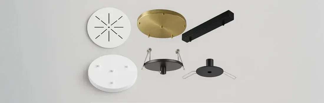 Assorted round and rectangular ceiling canopies in matte white, black, and brushed brass finishes on a light background