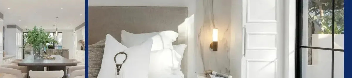 Cylindrical wall sconce with a bronze finish and frosted glass shade mounted on a marble bedroom wall