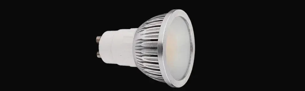 White GU10 globe with a silver metallic ribbed heat sink and a flat frosted glass lens against a black background