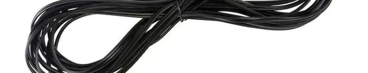 Coiled black electrical cable with a smooth finish isolated on a white background