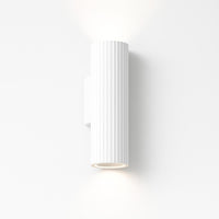 White cylindrical wall light fixture on a white background